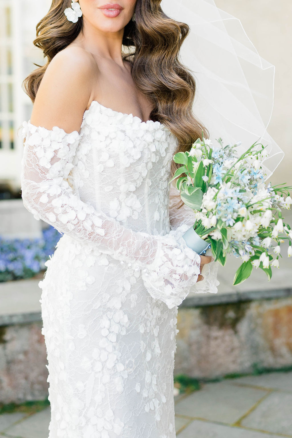 The Breakers Newport | Newport Photography By Caprio Captured Light And Airy | Bride wearing an off shoulder lace wedding gown holding dusty blue bouquet