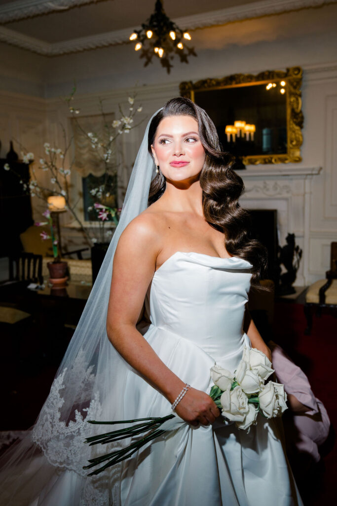 Rhode Island Wedding Photographer | Newport Wedding Photography Caprio Captured | Bride holding a bouquet of white flowers and wearing a floor length veil