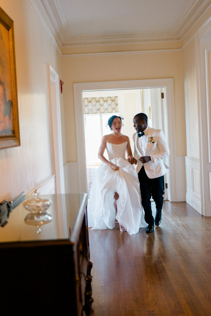 Aldrich Mansion Wedding | Bride and groom running in the Aldrich Mansion hallway 